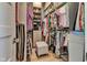 Walk in closet with a neutral gray stool and an organized wardrobe at 8146 W 875 S, Pendleton, IN 46064