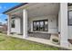 Inviting covered patio with stylish outdoor seating, a patterned rug, and direct access to the home's interior at 8146 W 875 S, Pendleton, IN 46064