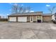 Three-car garage with a large driveway, seating, and ample parking space for multiple vehicles and outdoor projects at 8146 W 875 S, Pendleton, IN 46064