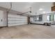 Spacious garage featuring a white Cadillac and white garage door and shelving at 8146 W 875 S, Pendleton, IN 46064