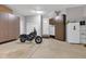 Spacious garage featuring a black motorcycle and lots of storage with floor to ceiling built in cabinetry at 8146 W 875 S, Pendleton, IN 46064