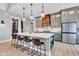 Stylish kitchen with island, barstool seating, pendant lights, and custom hood at 8146 W 875 S, Pendleton, IN 46064