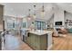 Open concept kitchen with island, stainless steel sink, pendant lights, and view into the living room at 8146 W 875 S, Pendleton, IN 46064