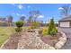 Landscaped yard featuring a decorative dry creek bed with a small bridge and border of river rock at 8146 W 875 S, Pendleton, IN 46064