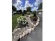 Beautifully landscaped yard featuring a dry creek bed with river rock, lush plantings, and a small bridge at 8146 W 875 S, Pendleton, IN 46064