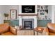 Cozy living room with a fireplace, built-in shelving, and stylish décor, creating a welcoming atmosphere at 8146 W 875 S, Pendleton, IN 46064