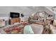 A spacious attic room featuring a comfortable sofa, TV, and an area rug, perfect for relaxation and entertainment at 8146 W 875 S, Pendleton, IN 46064