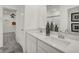 Bathroom featuring double sinks with granite counters, a walk-in closet, and modern fixtures at 8893 Alexander Ridge Dr, McCordsville, IN 46055