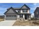 Charming two-story home featuring a two-car garage and a mix of siding and brick accents at 8893 Alexander Ridge Dr, McCordsville, IN 46055