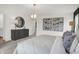 Bright main bedroom with hardwood floors, neutral decor, and modern lighting at 8893 Alexander Ridge Dr, McCordsville, IN 46055