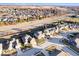 Stunning aerial view of a well-planned neighborhood with neatly lined houses, lush greenery, and a highway nearby at 10155 Pepper Tree Ln, Noblesville, IN 46060