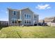 Expansive backyard with a well-maintained lawn, patio furniture, and a charming playset under a sunny sky at 10155 Pepper Tree Ln, Noblesville, IN 46060