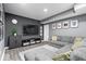 Finished basement features a large sectional sofa, TV, and neutral decor at 10155 Pepper Tree Ln, Noblesville, IN 46060