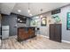 Finished basement featuring a bar area with seating, pendant lights and a mounted TV at 10155 Pepper Tree Ln, Noblesville, IN 46060