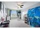 Bright bedroom featuring carpeted floors, a ceiling fan, and neutral walls complemented by a blue accent wall at 10155 Pepper Tree Ln, Noblesville, IN 46060