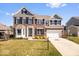 Charming two-story brick home with a well-manicured lawn and attached two-car garage at 10155 Pepper Tree Ln, Noblesville, IN 46060