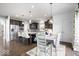 Spacious kitchen features stainless steel appliances, pendant lighting, and a large island with seating at 10155 Pepper Tree Ln, Noblesville, IN 46060