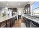 Beautiful kitchen with dark cabinetry, a center island, and stainless steel appliances at 10155 Pepper Tree Ln, Noblesville, IN 46060