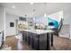 Open concept kitchen featuring an island with dark cabinets, hardwood floors, and an adjacent eating area at 10155 Pepper Tree Ln, Noblesville, IN 46060