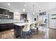 Modern kitchen with a large island, stainless steel appliances, and a dining area at 10155 Pepper Tree Ln, Noblesville, IN 46060