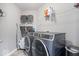 Modern laundry room with front-load washer and dryer, ample shelving and modern grey walls at 10155 Pepper Tree Ln, Noblesville, IN 46060