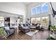 A spacious living room with hardwood floors, lots of light, and comfortable seating at 10155 Pepper Tree Ln, Noblesville, IN 46060