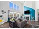 Open-concept living room with a fireplace, modern decor, and large windows at 10155 Pepper Tree Ln, Noblesville, IN 46060