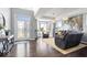 Bright living room with hardwood floors, ample natural light, and comfortable seating at 10155 Pepper Tree Ln, Noblesville, IN 46060