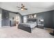 Spacious main bedroom featuring a large bed, neutral carpet, and an ensuite bathroom at 10155 Pepper Tree Ln, Noblesville, IN 46060