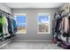 Spacious walk-in closet with wall-to-wall shelving units and views from the double windows at 10155 Pepper Tree Ln, Noblesville, IN 46060