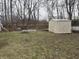 Green backyard with shed and mature trees, offering plenty of space at 1016 Alden Dr, Fortville, IN 46040