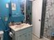 Bright bathroom featuring a white vanity with sink, blue walls, and decorative accents at 1016 Alden Dr, Fortville, IN 46040