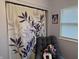 This bedroom shows a dark colored chair, a large leafy curtain, and a window at 1016 Alden Dr, Fortville, IN 46040
