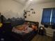 A bedroom with a themed comforter and a mountain scene painted on the wall at 1016 Alden Dr, Fortville, IN 46040