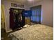 A cozy bedroom is equipped with a flat-screen TV, closet, and a comfortable bed for relaxation and entertainment at 1016 Alden Dr, Fortville, IN 46040