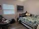 This bedroom has a floral bedspread and a tv, offering a cozy place to relax at 1016 Alden Dr, Fortville, IN 46040