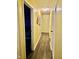 Hallway with hardwood floors, yellow walls, and doors leading to various rooms at 1016 Alden Dr, Fortville, IN 46040