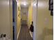 Hallway features neutral walls, hardwood floors, and light fixtures, creating a warm ambiance at 1016 Alden Dr, Fortville, IN 46040