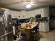 Well-lit kitchen equipped with modern stainless steel appliances, white cabinetry, and a functional center island at 1016 Alden Dr, Fortville, IN 46040