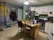 Practical kitchen featuring stainless steel appliances, a center island with seating, and durable tile flooring at 1016 Alden Dr, Fortville, IN 46040