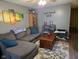 A comfortable living room features a sectional sofa, hardwood flooring, a coffee table, and decorative wall art at 1016 Alden Dr, Fortville, IN 46040