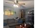 Cozy living room featuring a ceiling fan, a comfortable gray couch, and a wooden bookcase at 1016 Alden Dr, Fortville, IN 46040