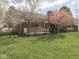 Expansive backyard featuring well-maintained lawn and brick home with a covered porch at 10343 Waveland Cir, Fishers, IN 46038