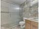 Bathroom featuring a glass enclosed shower, tile accents, and vanity with sink at 10343 Waveland Cir, Fishers, IN 46038