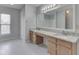 Large bathroom with double vanity, granite countertops, and window at 10343 Waveland Cir, Fishers, IN 46038