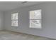 Bright bedroom featuring neutral carpet and two windows with blinds, offering plenty of natural light at 10343 Waveland Cir, Fishers, IN 46038
