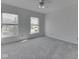 A sunlit bedroom featuring carpet and two windows offering a view at 10343 Waveland Cir, Fishers, IN 46038