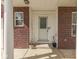 Inviting front entrance featuring a white door with glass, framed by brick and white columns at 10343 Waveland Cir, Fishers, IN 46038