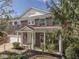 Charming red brick home featuring a welcoming front porch with white columns and a beautifully landscaped front yard at 10343 Waveland Cir, Fishers, IN 46038