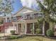 Charming red brick home featuring a welcoming front porch with white columns and a beautifully landscaped front yard at 10343 Waveland Cir, Fishers, IN 46038